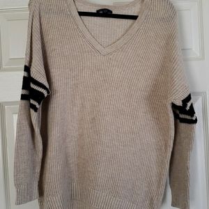 Tan sweater with two black stripes on sleeves.